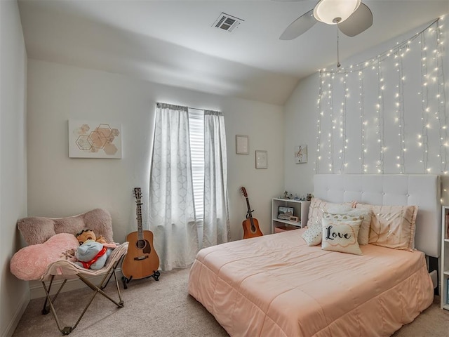 carpeted bedroom with vaulted ceiling and ceiling fan