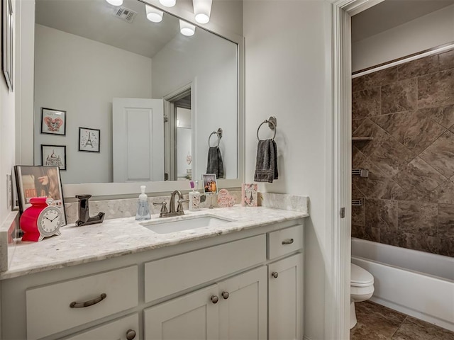 full bathroom with vanity, toilet, and tiled shower / bath