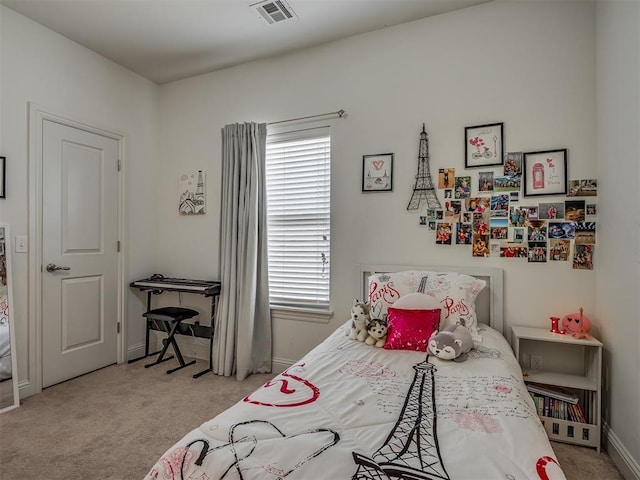 bedroom featuring light carpet