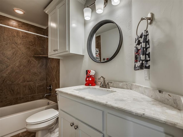 full bathroom featuring tiled shower / bath combo, toilet, and vanity