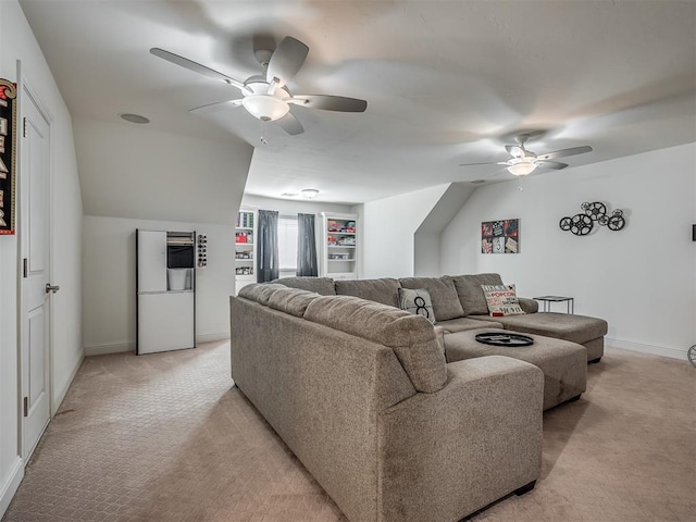 living room with ceiling fan, light colored carpet, and built in shelves