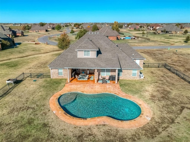 view of pool with a patio area and a lawn