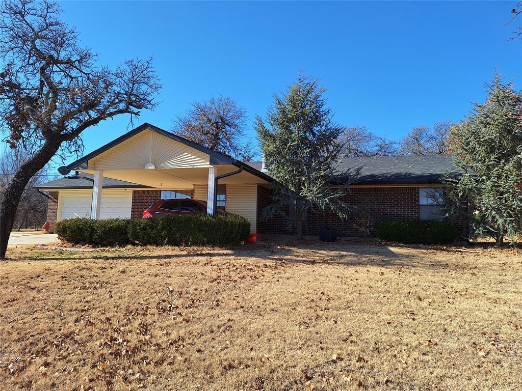 ranch-style house featuring an attached garage and brick siding