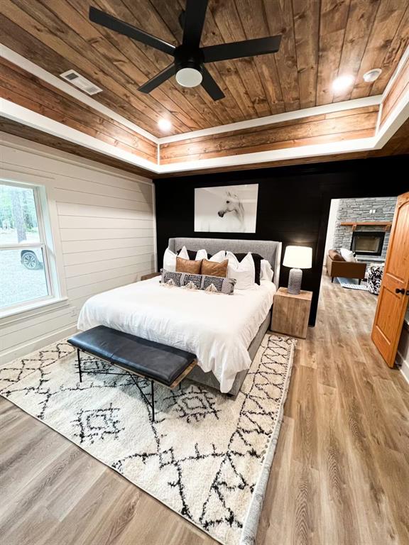 bedroom featuring ceiling fan, wood ceiling, and light hardwood / wood-style flooring