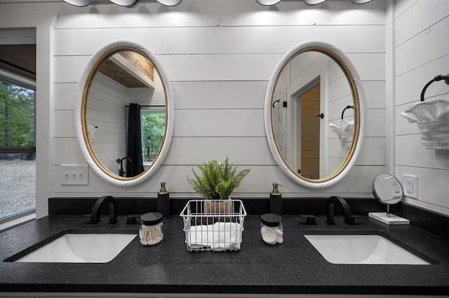 bathroom featuring wooden walls and vanity