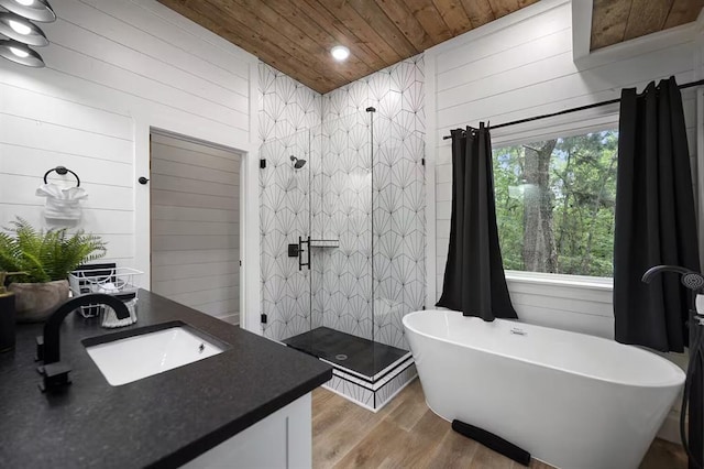 bathroom featuring hardwood / wood-style flooring, vanity, wood ceiling, and wooden walls