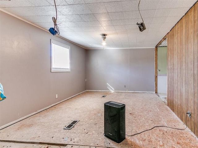 spare room with wood walls