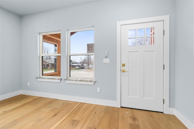 entrance foyer with light hardwood / wood-style floors and a wealth of natural light