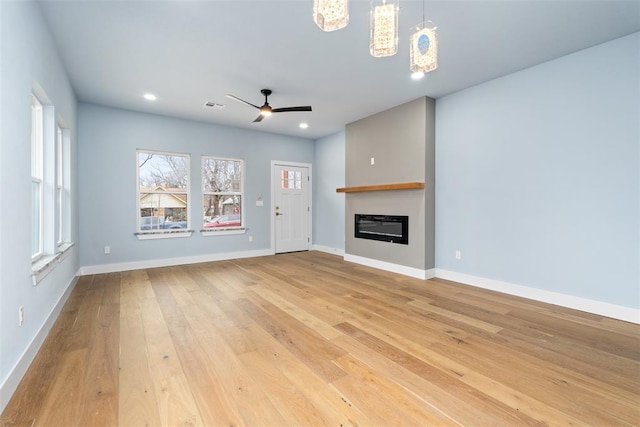 unfurnished living room with ceiling fan and light hardwood / wood-style flooring