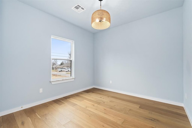 empty room with hardwood / wood-style flooring