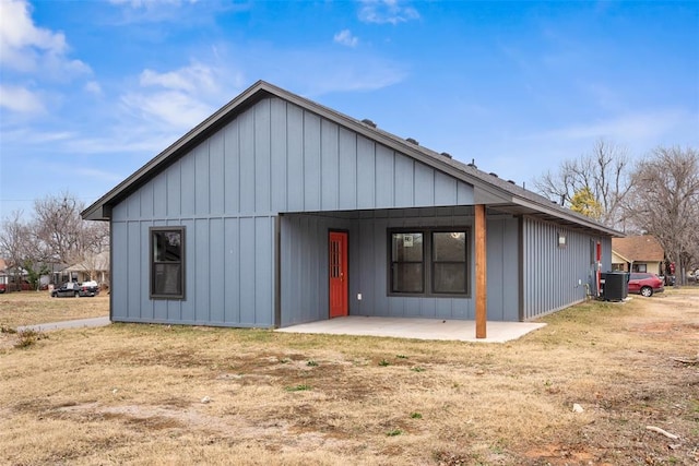 rear view of house with a patio and central AC