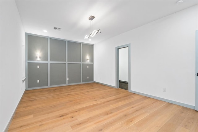 spare room featuring light wood-type flooring