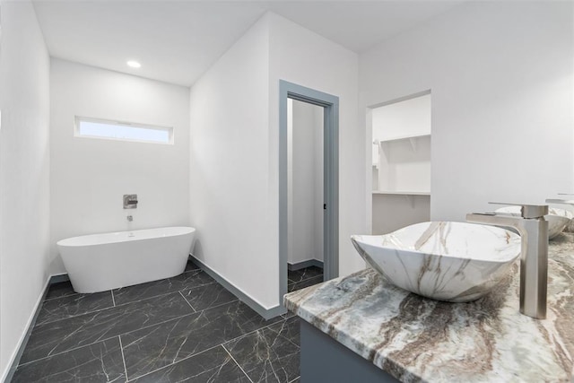 bathroom featuring sink and a tub