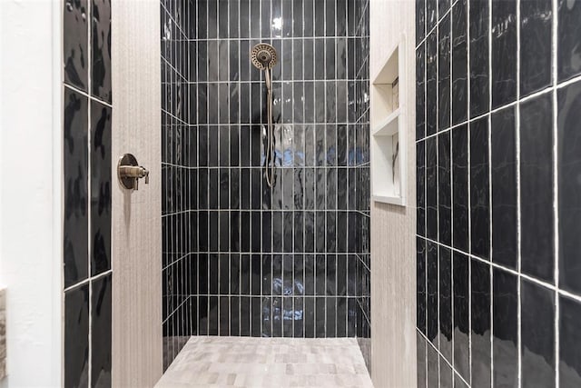 bathroom with a tile shower