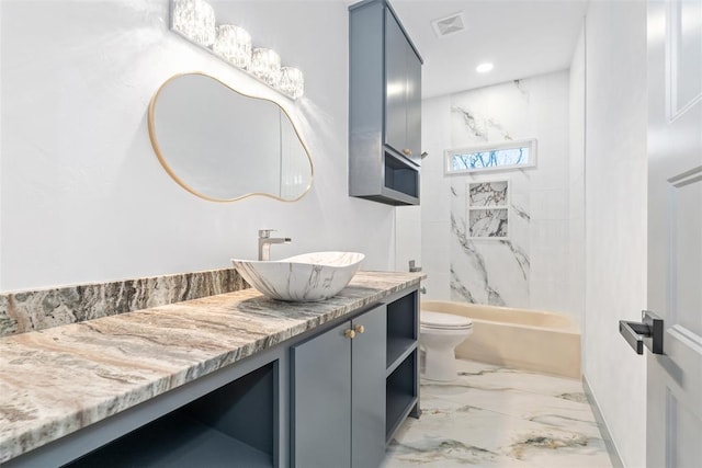 full bathroom featuring vanity, toilet, and tiled shower / bath