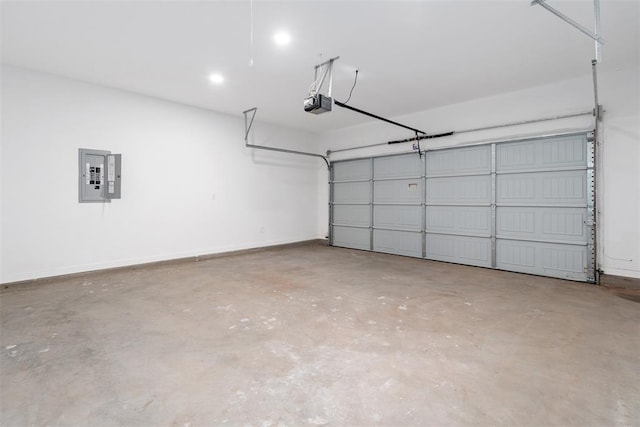 garage with a garage door opener and electric panel