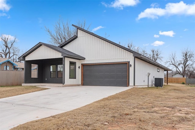 modern farmhouse style home featuring a garage and cooling unit