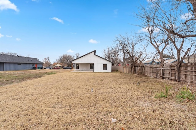 rear view of property with a lawn