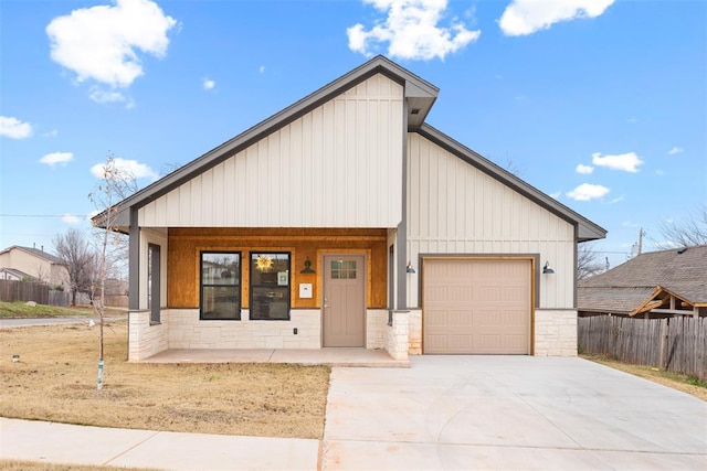 view of front of property featuring covered porch and a garage