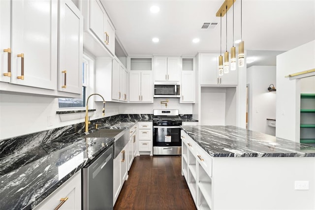 kitchen featuring white cabinets, dark stone counters, and appliances with stainless steel finishes