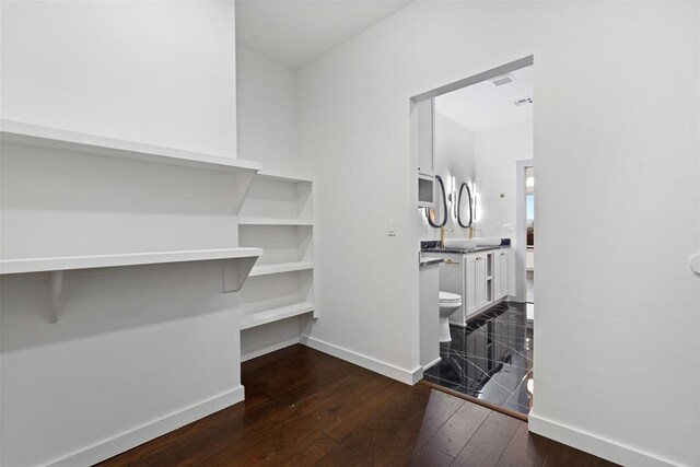 spacious closet with dark hardwood / wood-style floors