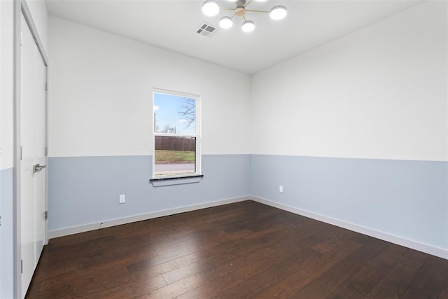 spare room with dark hardwood / wood-style floors