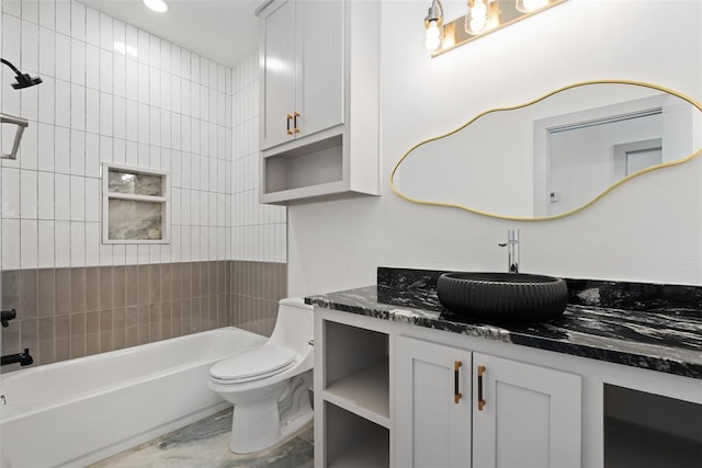 full bathroom featuring vanity, toilet, and tiled shower / bath combo