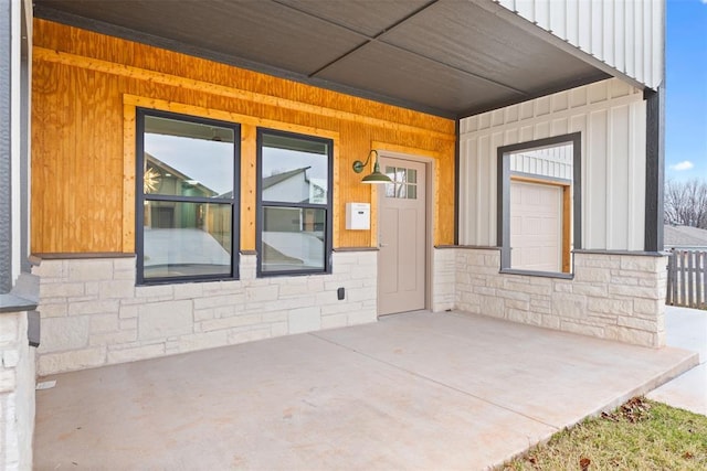 view of exterior entry featuring a porch