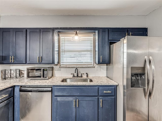 kitchen featuring blue cabinetry, stainless steel appliances, and sink