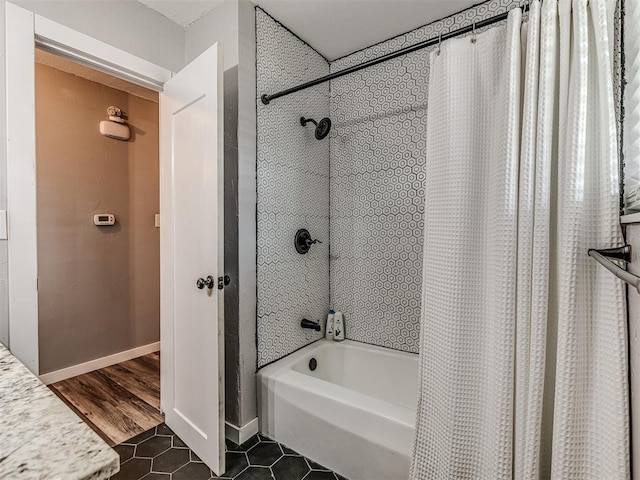 bathroom with tile patterned flooring and shower / bath combo