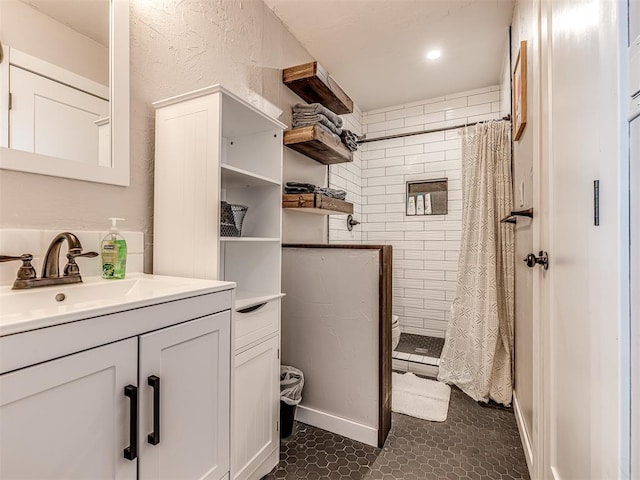 bathroom featuring tile patterned flooring, vanity, and curtained shower