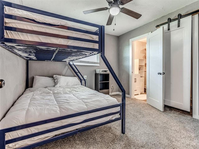 carpeted bedroom with ceiling fan and ensuite bath