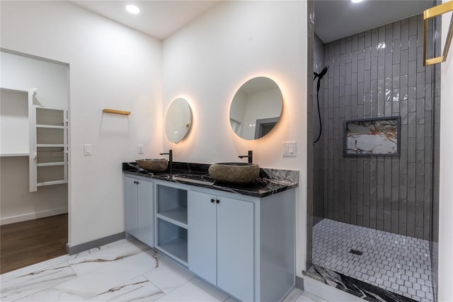 bathroom featuring vanity and tiled shower