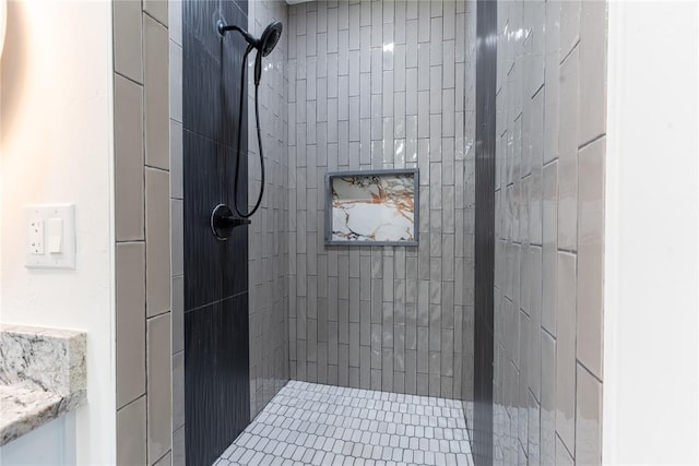 bathroom featuring vanity and tiled shower