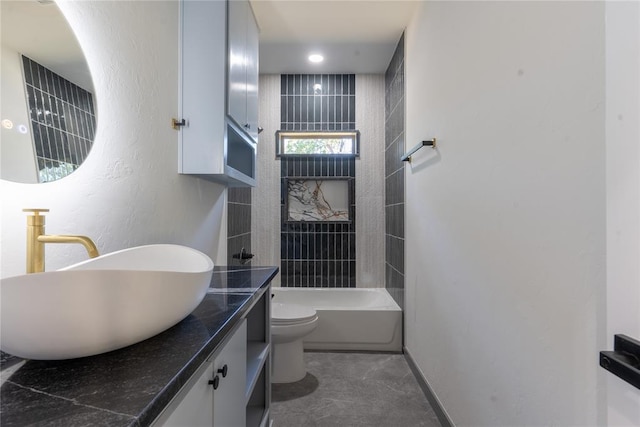 full bathroom with vanity, tiled shower / bath combo, and toilet