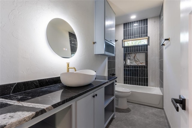 full bathroom with vanity, tiled shower / bath combo, and toilet