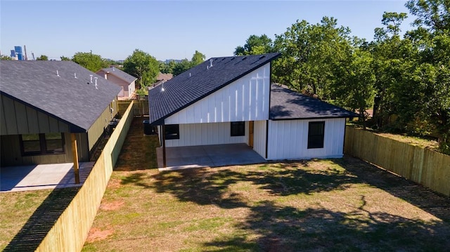 rear view of house with a yard and a patio area