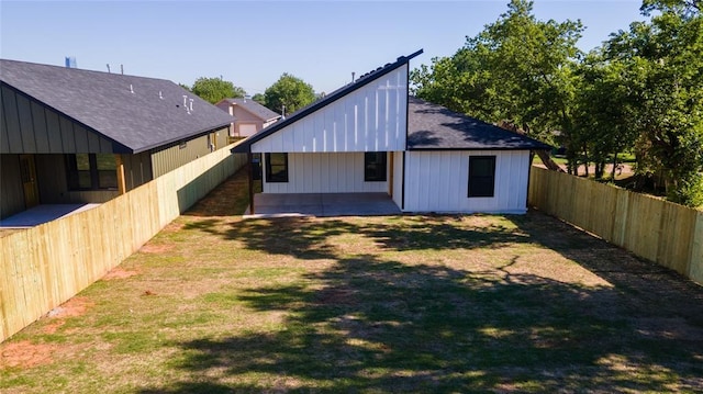 rear view of property with a lawn and a patio area