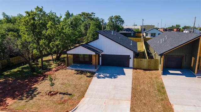 modern farmhouse with covered porch and a garage