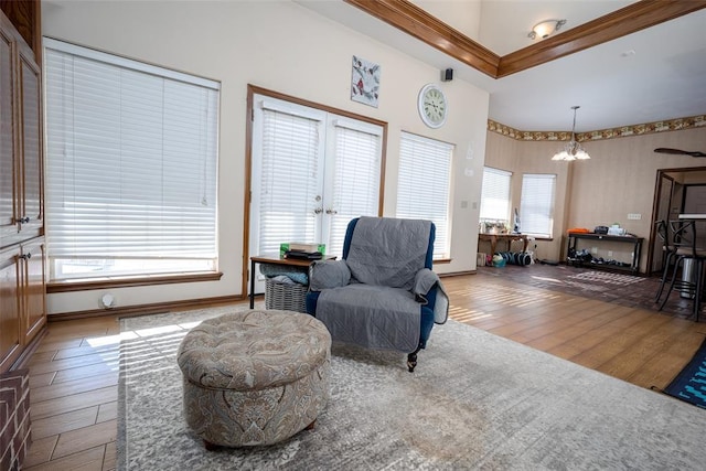 living area featuring a notable chandelier and light wood-type flooring