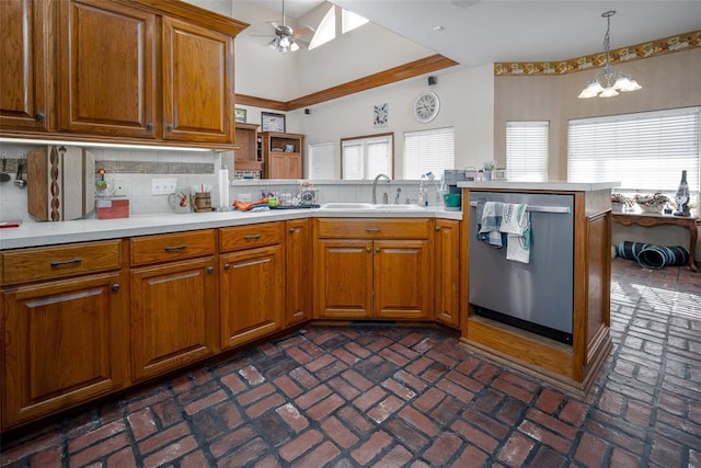 kitchen with sink, hanging light fixtures, stainless steel dishwasher, kitchen peninsula, and decorative backsplash