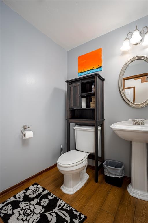 bathroom with hardwood / wood-style floors and toilet