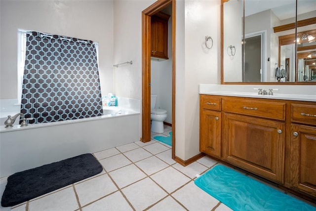 bathroom with tile patterned floors, a washtub, toilet, and vanity