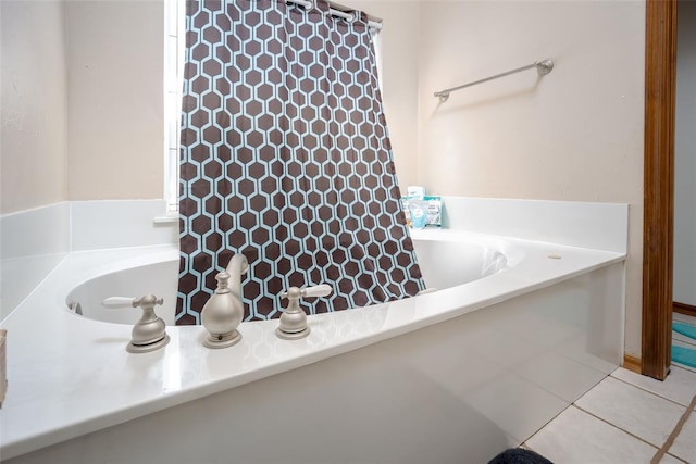 bathroom with tile patterned flooring and a bathtub