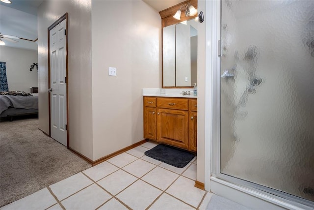 bathroom featuring tile patterned flooring, ceiling fan, an enclosed shower, and vanity