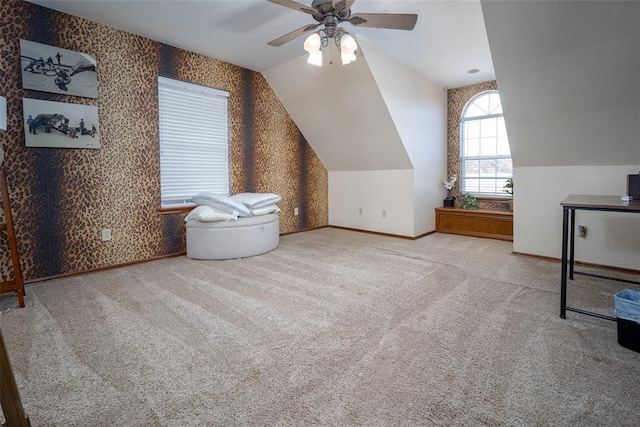 bonus room featuring ceiling fan, light carpet, and vaulted ceiling