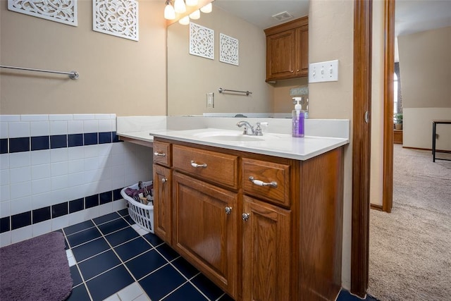 bathroom with vanity, tile patterned floors, and tile walls