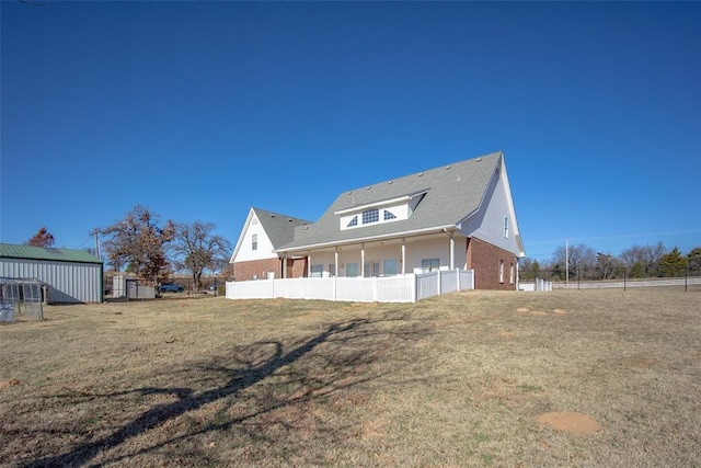 back of property with a porch and an outbuilding