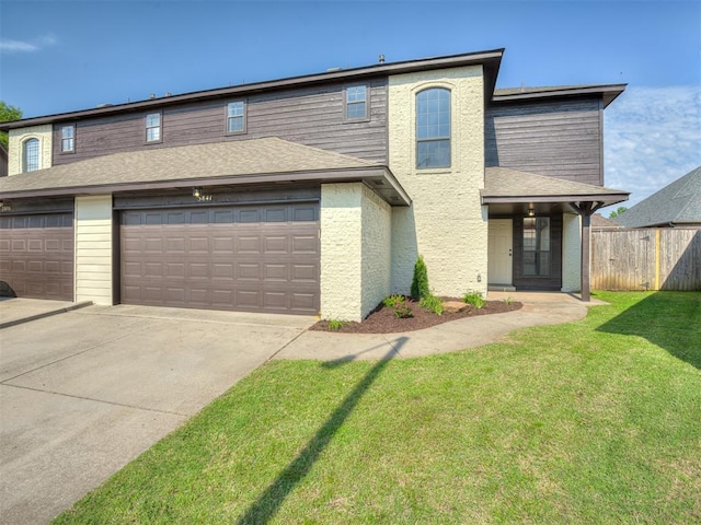 view of front property featuring a garage and a front lawn