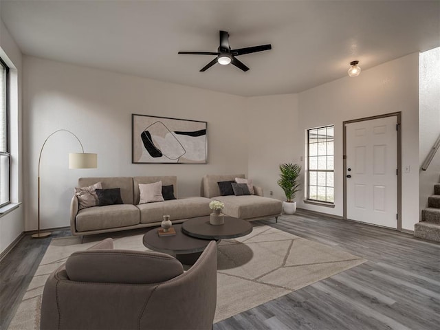 living room featuring ceiling fan and hardwood / wood-style flooring